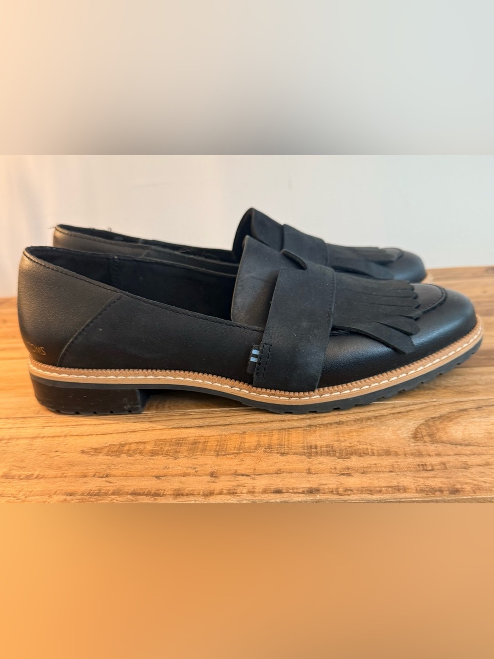 Toms Black Fringe Penny Loafers with Tan Trim